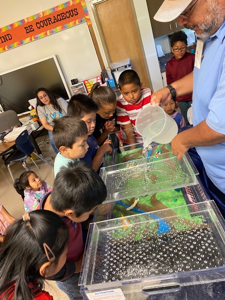 boys and girls setting up the floodplain model.